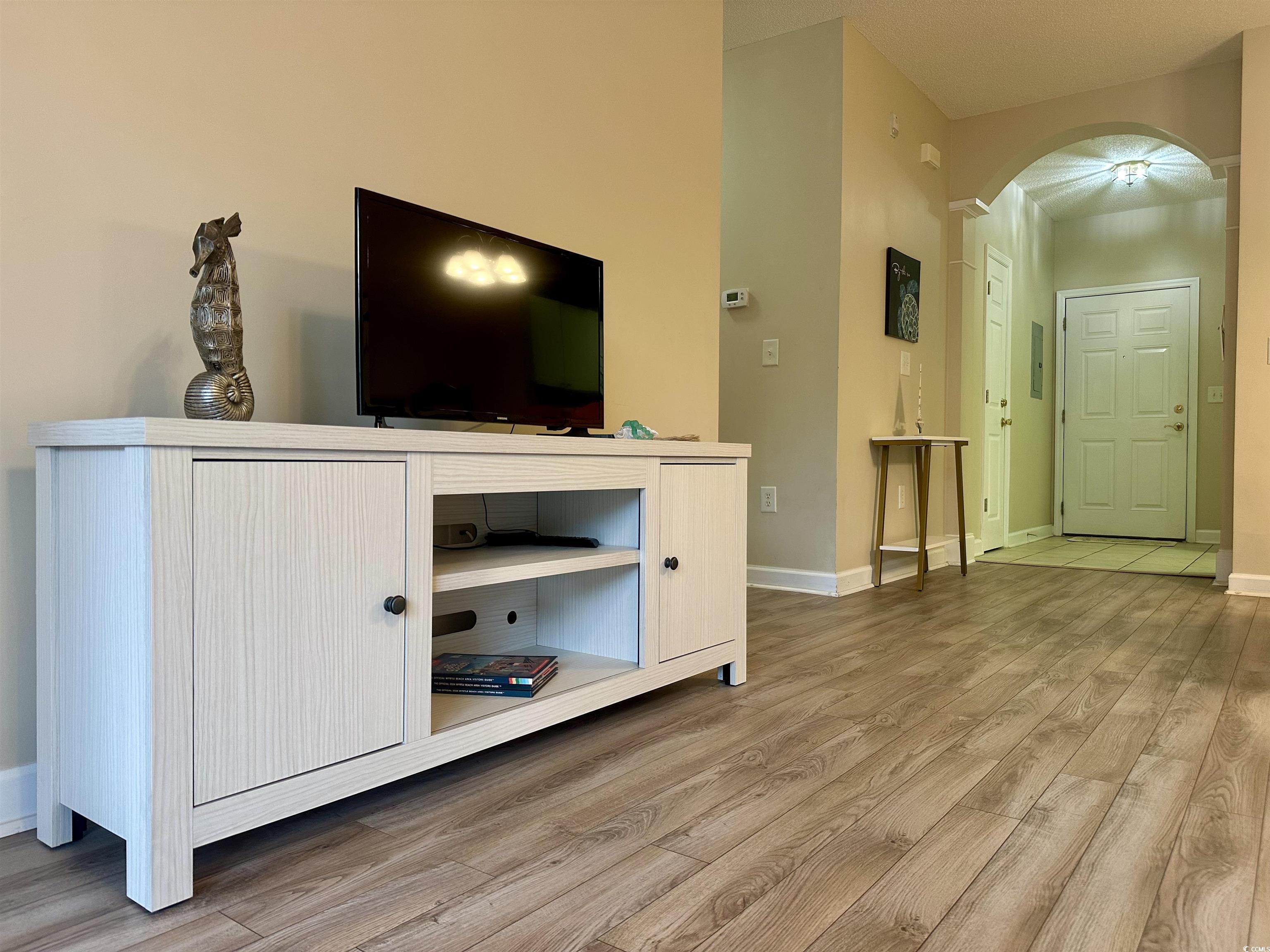 Image 4: Living area featuring arched walkways, newer wood Image 4: Living area featuring arched walkways, newer wood