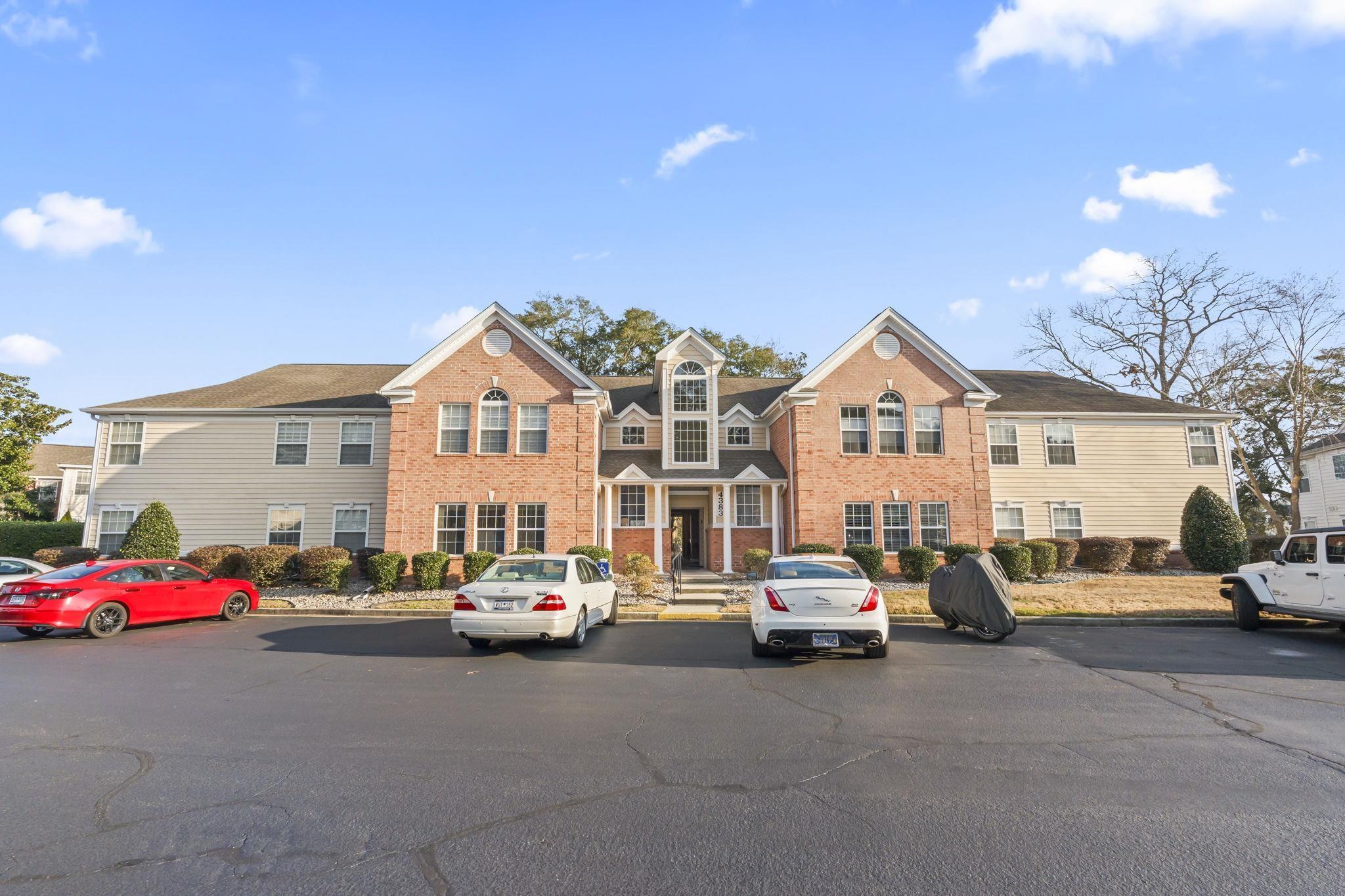 Image 1: View of front facade with a residential view, bric Image 1: View of front facade with a residential view, bric