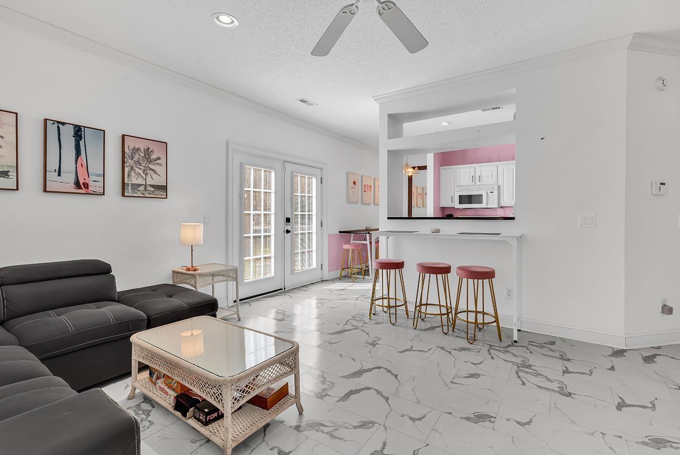 Image 2: Living room featuring crown molding, a textured ce Image 2: Living room featuring crown molding, a textured ce