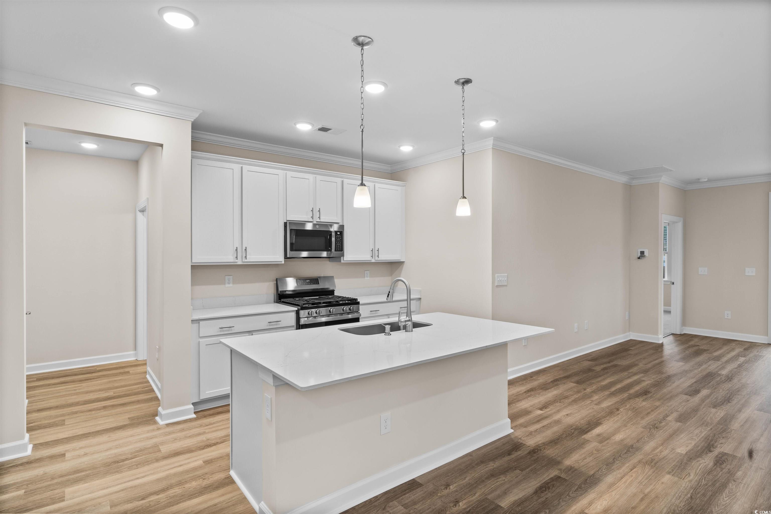Image 3: Kitchen featuring stainless steel appliances, whit