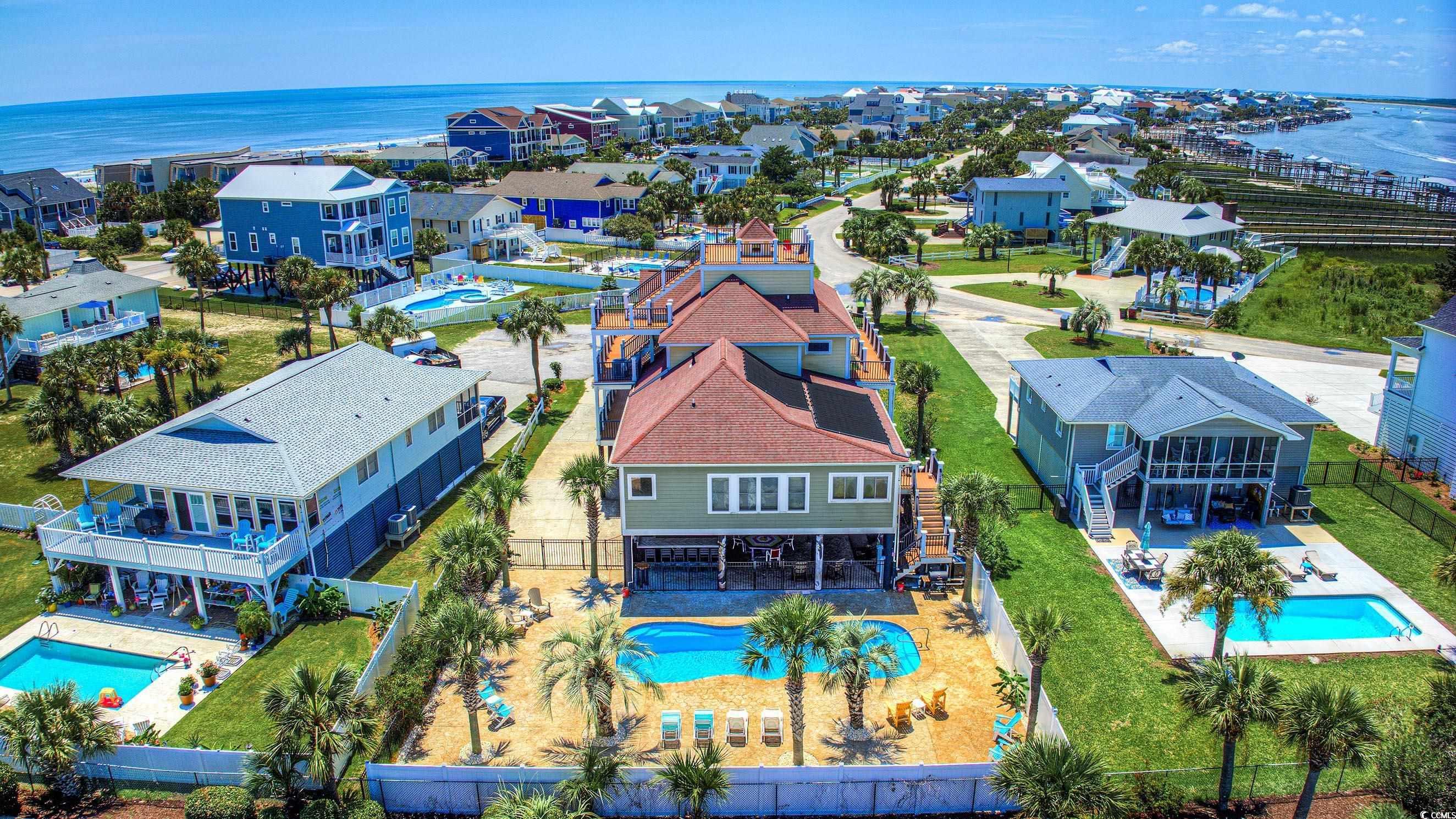 Image 2: Aerial view of residential area with a pool