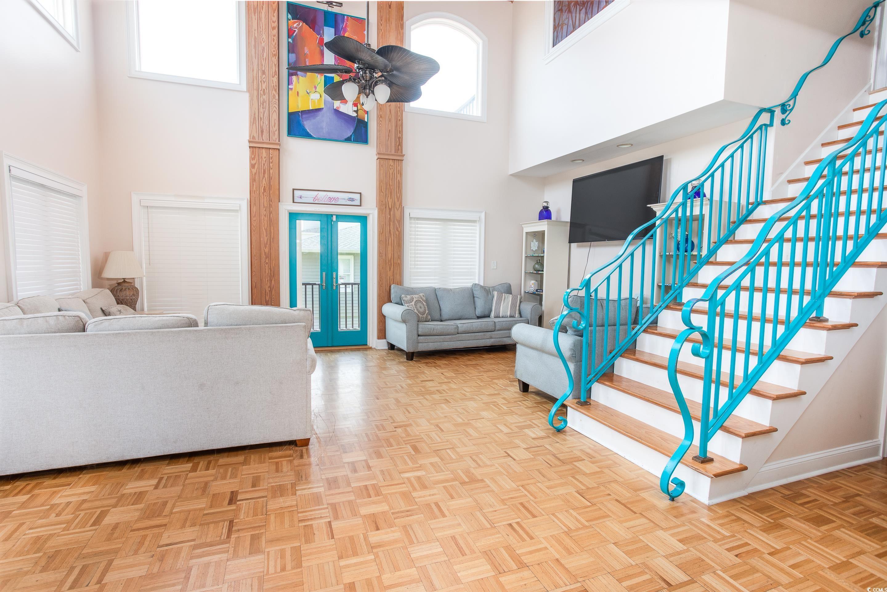 Image 3: Foyer entrance with stairs and a high ceiling