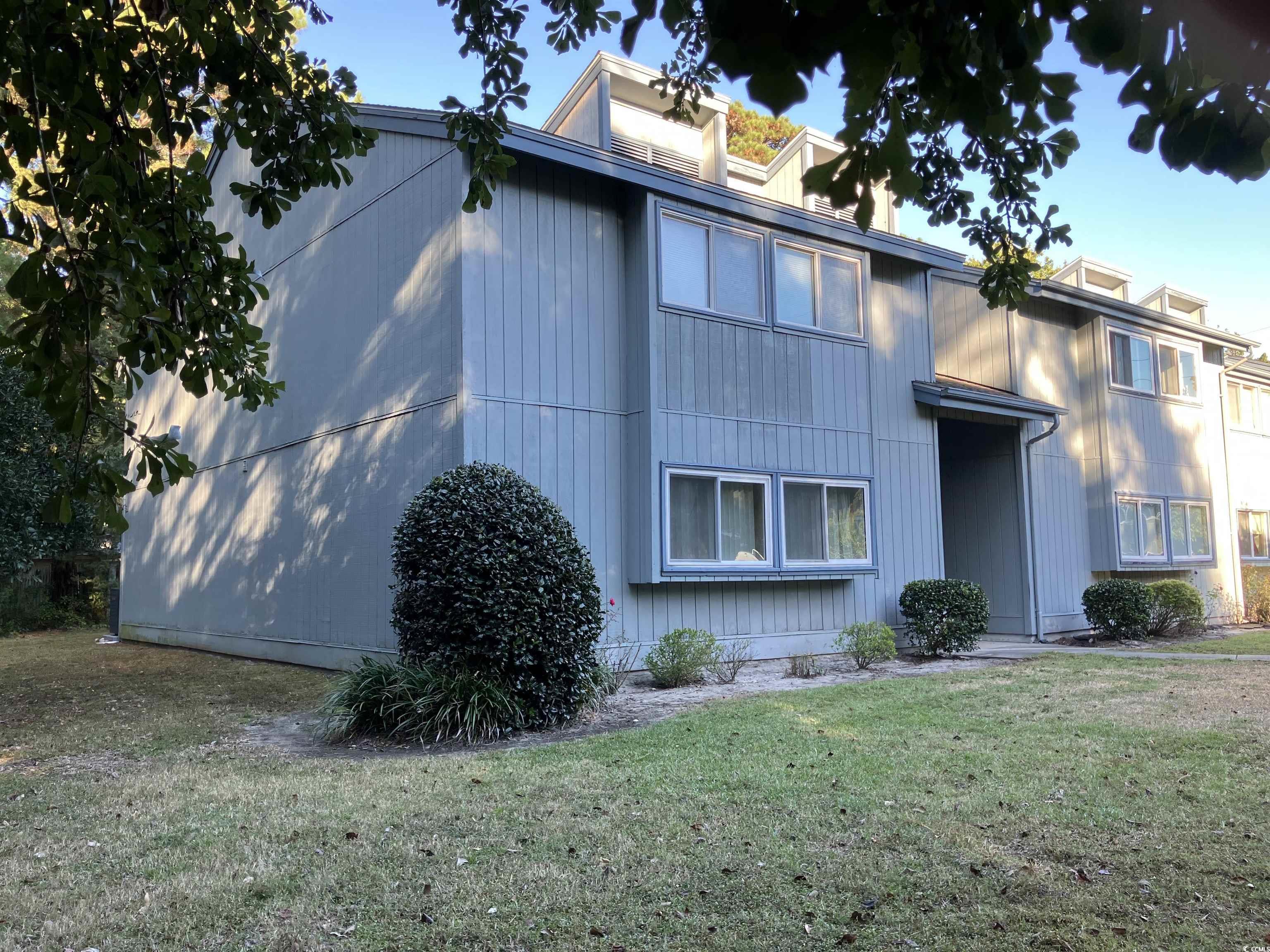 Image 1: View of front facade with a front lawn