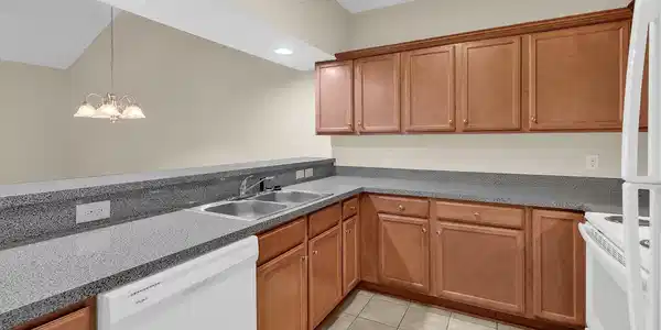 Image 3: Kitchen featuring white appliances, brown cabinets Image 3: Kitchen featuring white appliances, brown cabinets