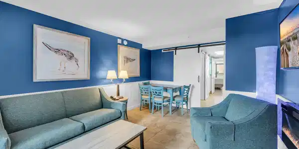 Image 2: Living room featuring a barn door, crown molding,