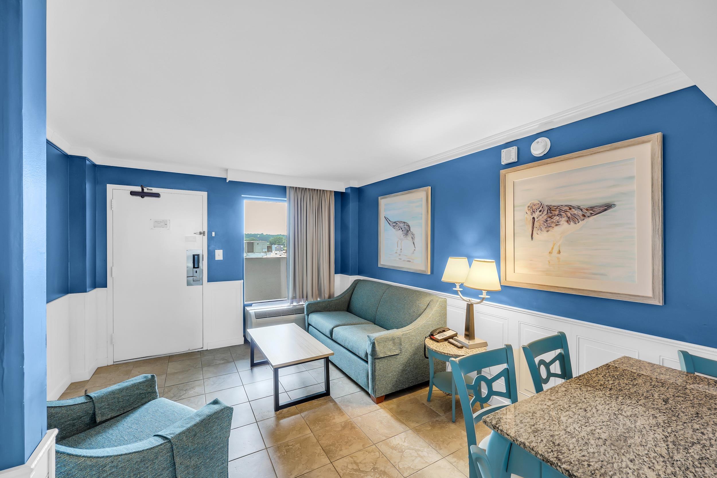 Image 4: Living area featuring wainscoting, a decorative wa