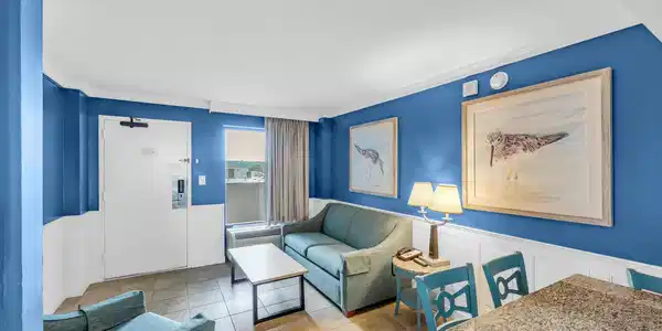 Image 4: Living area featuring wainscoting, a decorative wa