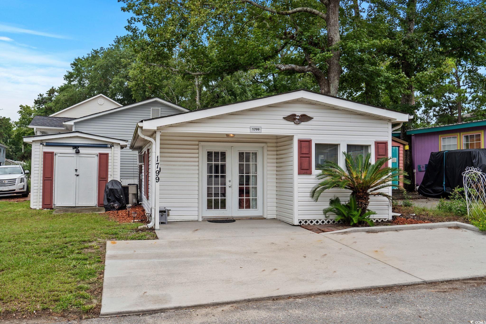 Image 2: View of front of property with french doors, a fro Image 2: View of front of property with french doors, a fro