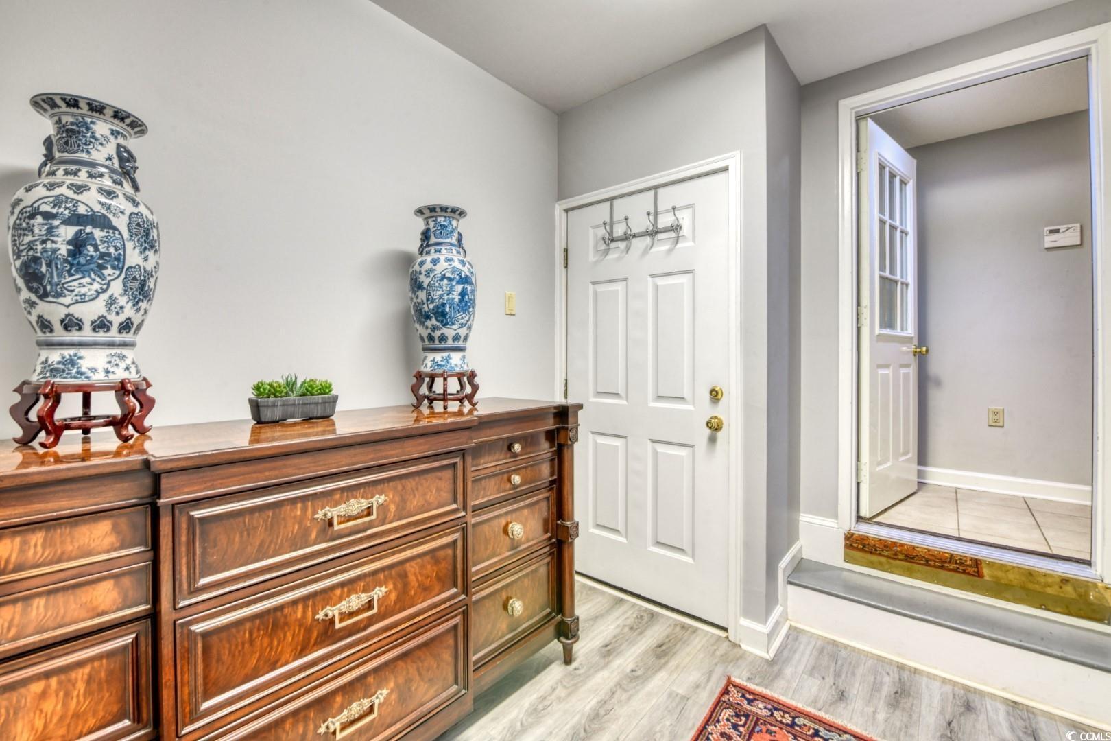 Image 3: Foyer entrance with light wood finished floors and