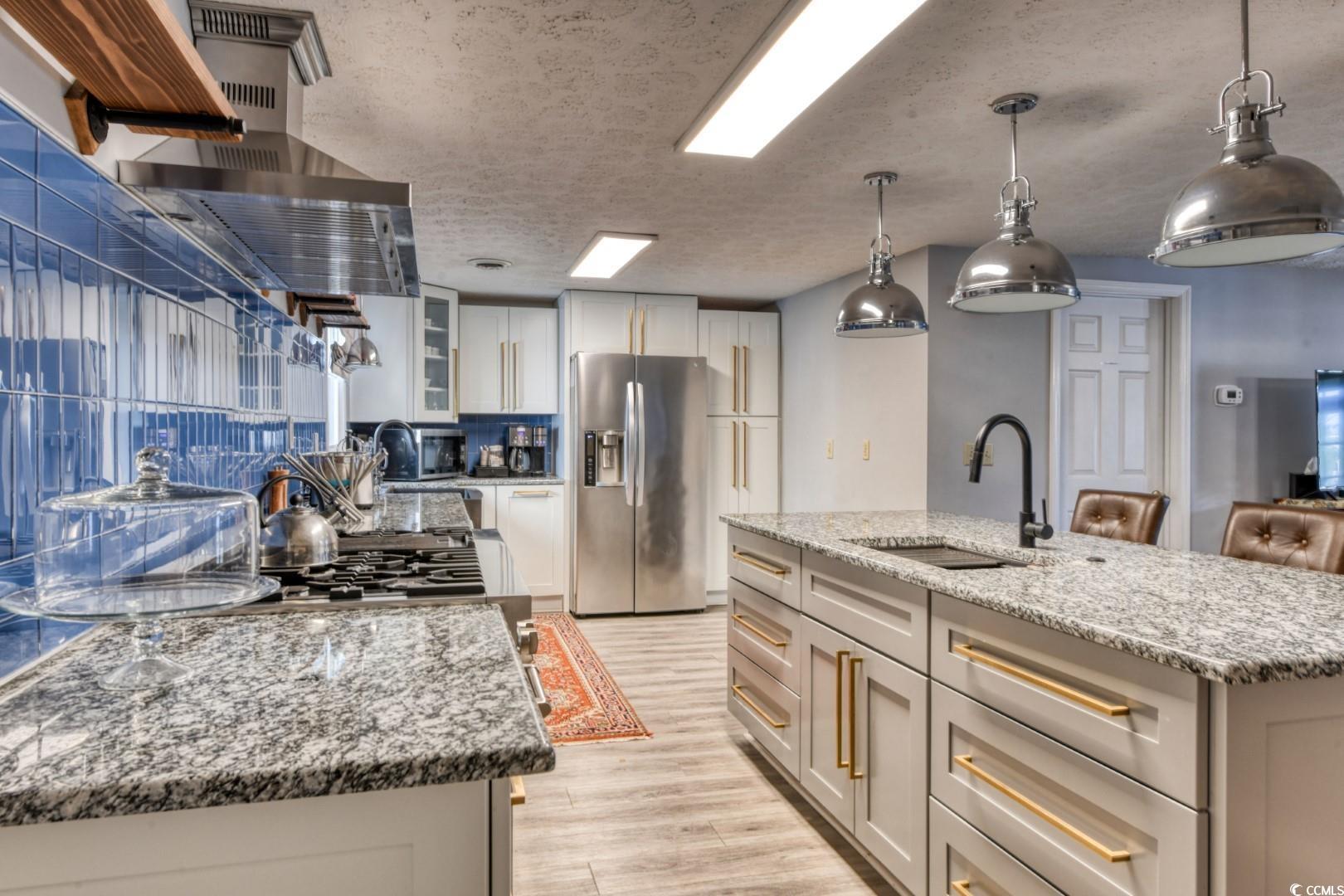 Image 4: Kitchen featuring decorative light fixtures, light