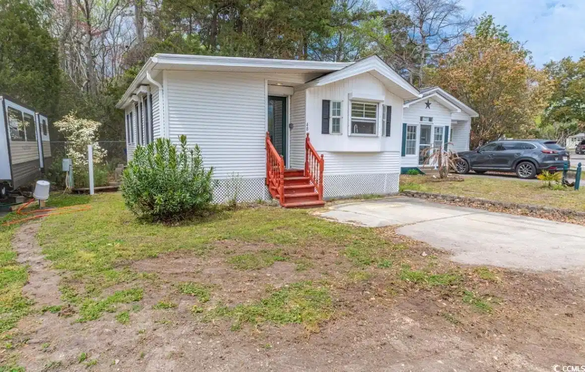 Image 1: View of front of property featuring entry steps an