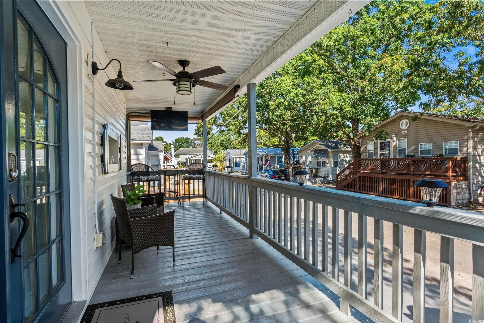 Image 3: Deck with a ceiling fan and a residential view Image 3: Deck with a ceiling fan and a residential view