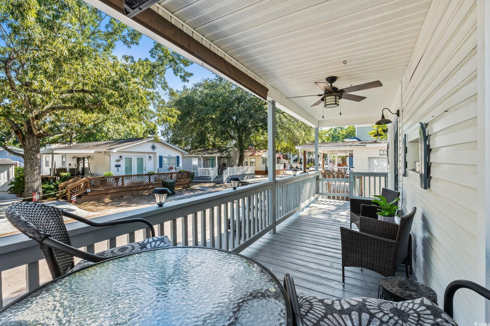 Image 4: Wooden terrace with a ceiling fan and a residentia Image 4: Wooden terrace with a ceiling fan and a residentia