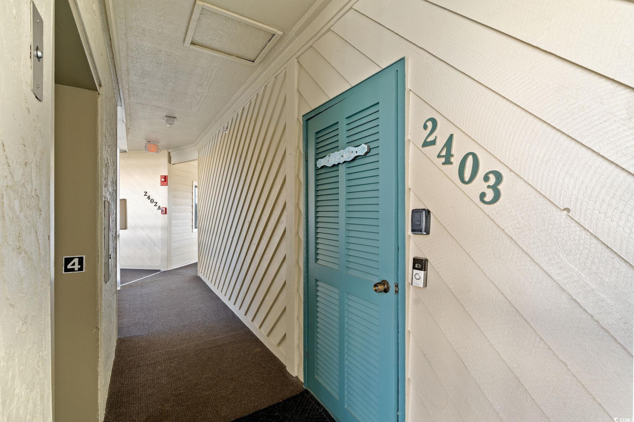 Image 2: Hall with wooden walls and dark carpet