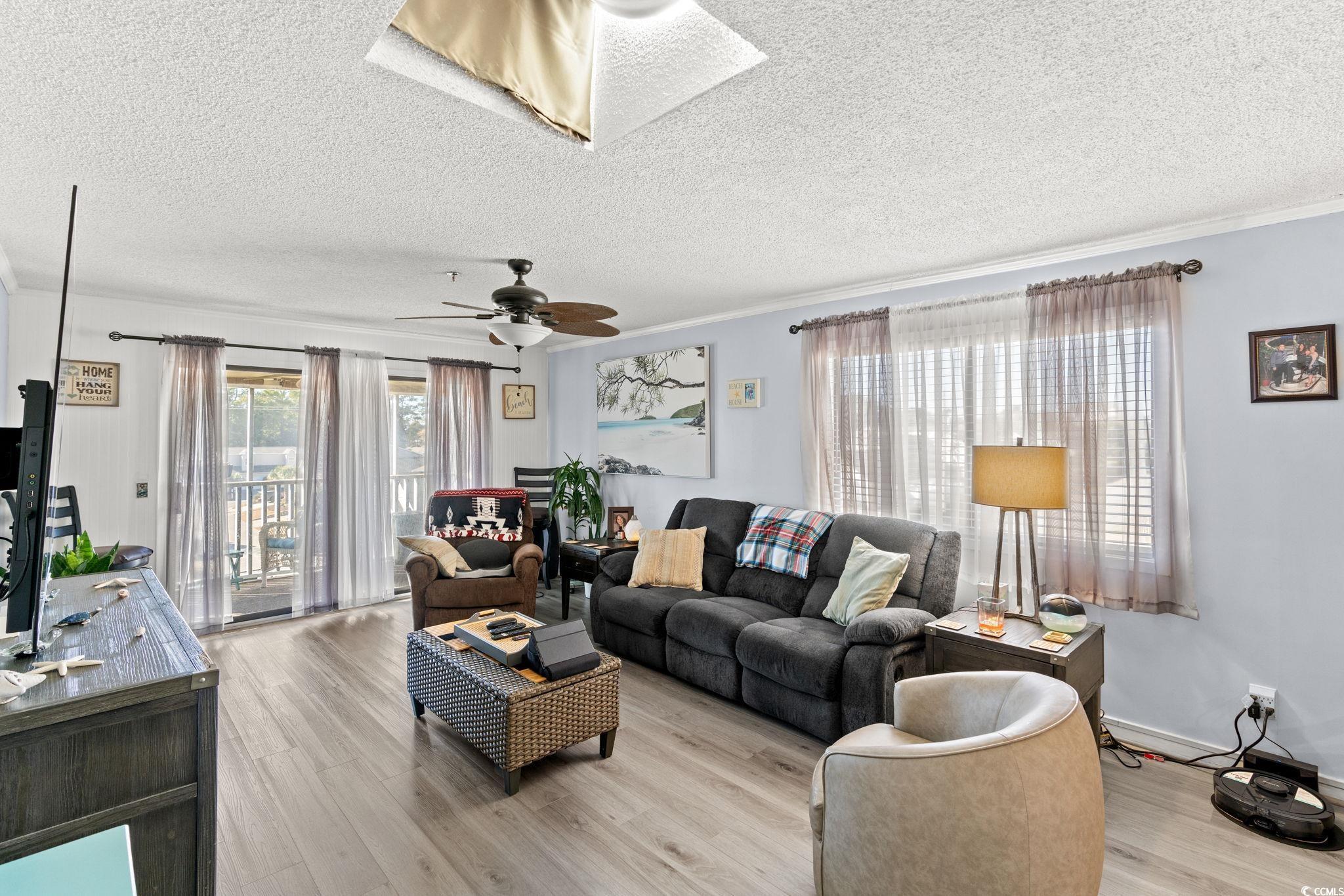 Image 4: Living room featuring light wood-style floors, a t
