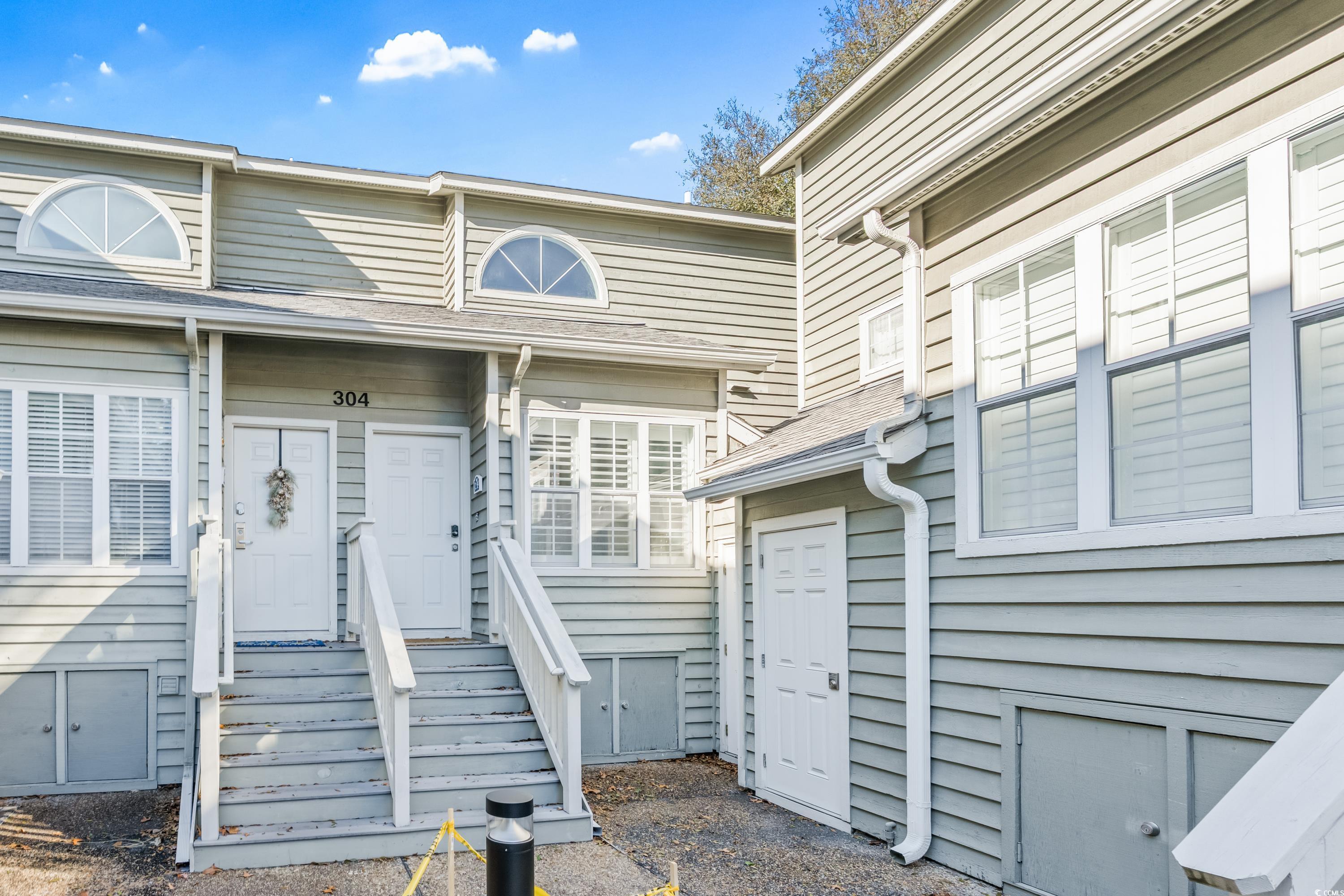 Image 1: Property entrance featuring roof with shingles Image 1: Property entrance featuring roof with shingles