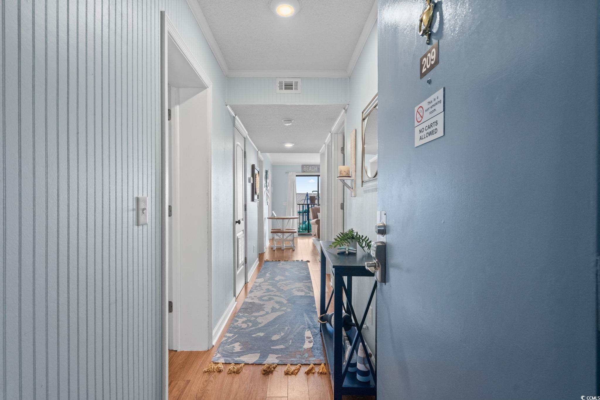 Image 2: Corridor featuring light wood-type flooring, crown Image 2: Corridor featuring light wood-type flooring, crown