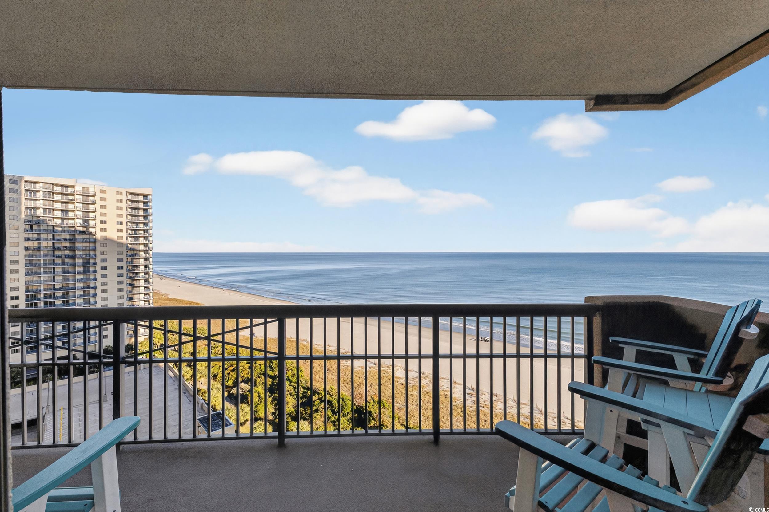 Image 2: Balcony featuring view of water and beach
