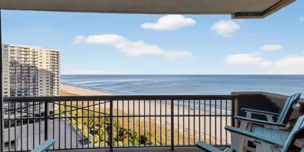 Image 2: Balcony featuring view of water and beach