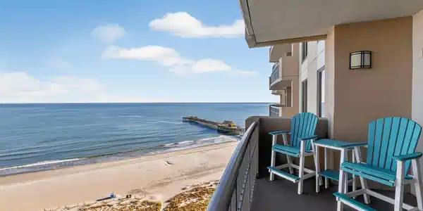 Image 3: Balcony with view of water and beach