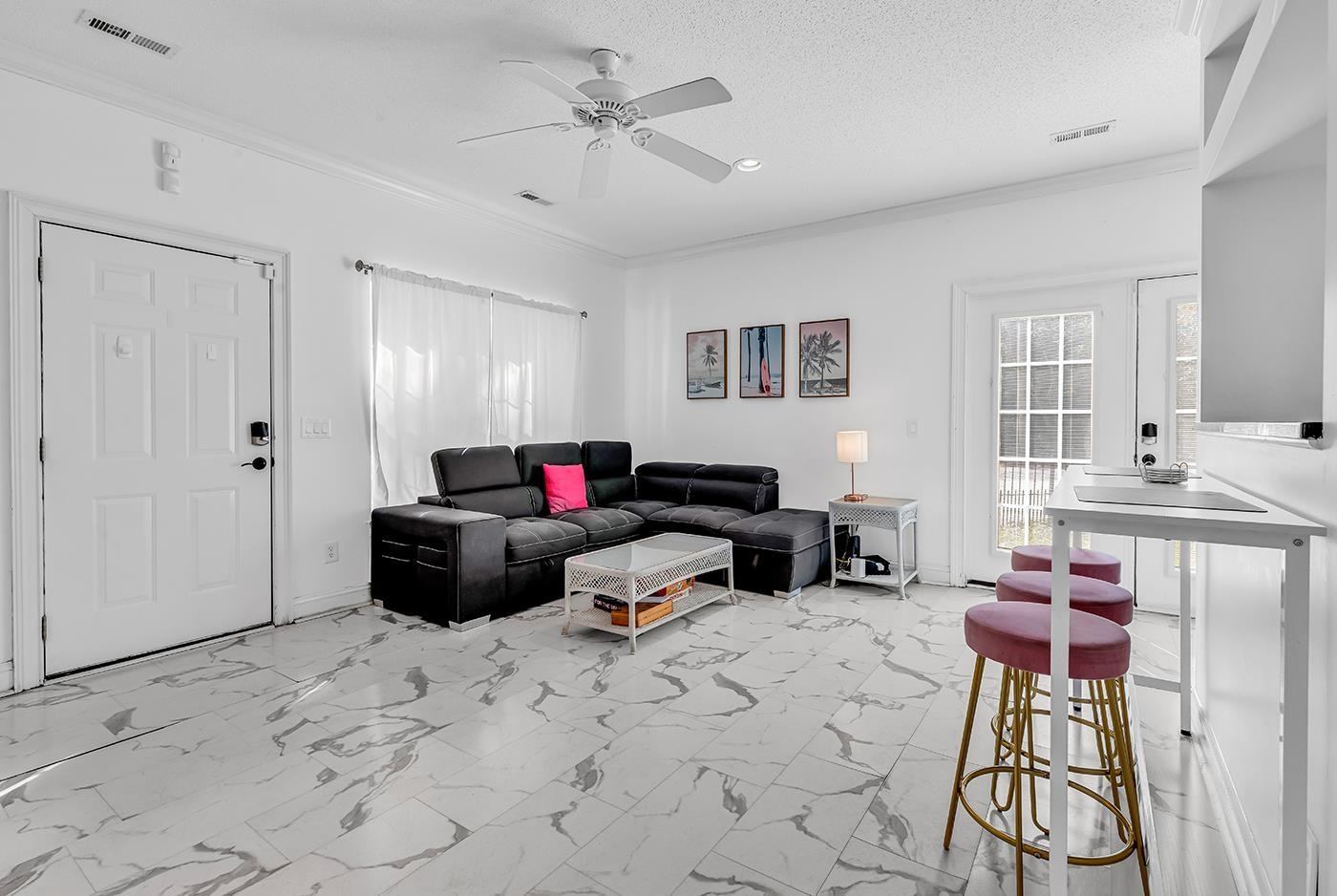 Image 4: Living area featuring light marble finish floors, Image 4: Living area featuring light marble finish floors,