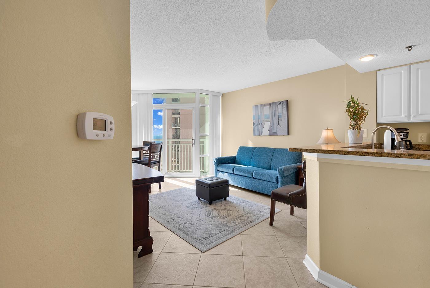 Image 3: Living area with a textured ceiling, expansive win