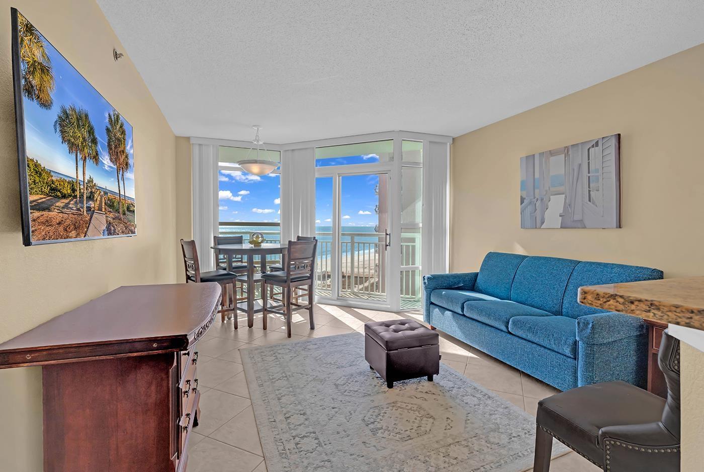 Image 4: Living room featuring a wall of windows, a texture