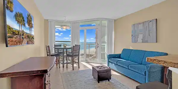 Image 4: Living room featuring a wall of windows, a texture Image 4: Living room featuring a wall of windows, a texture