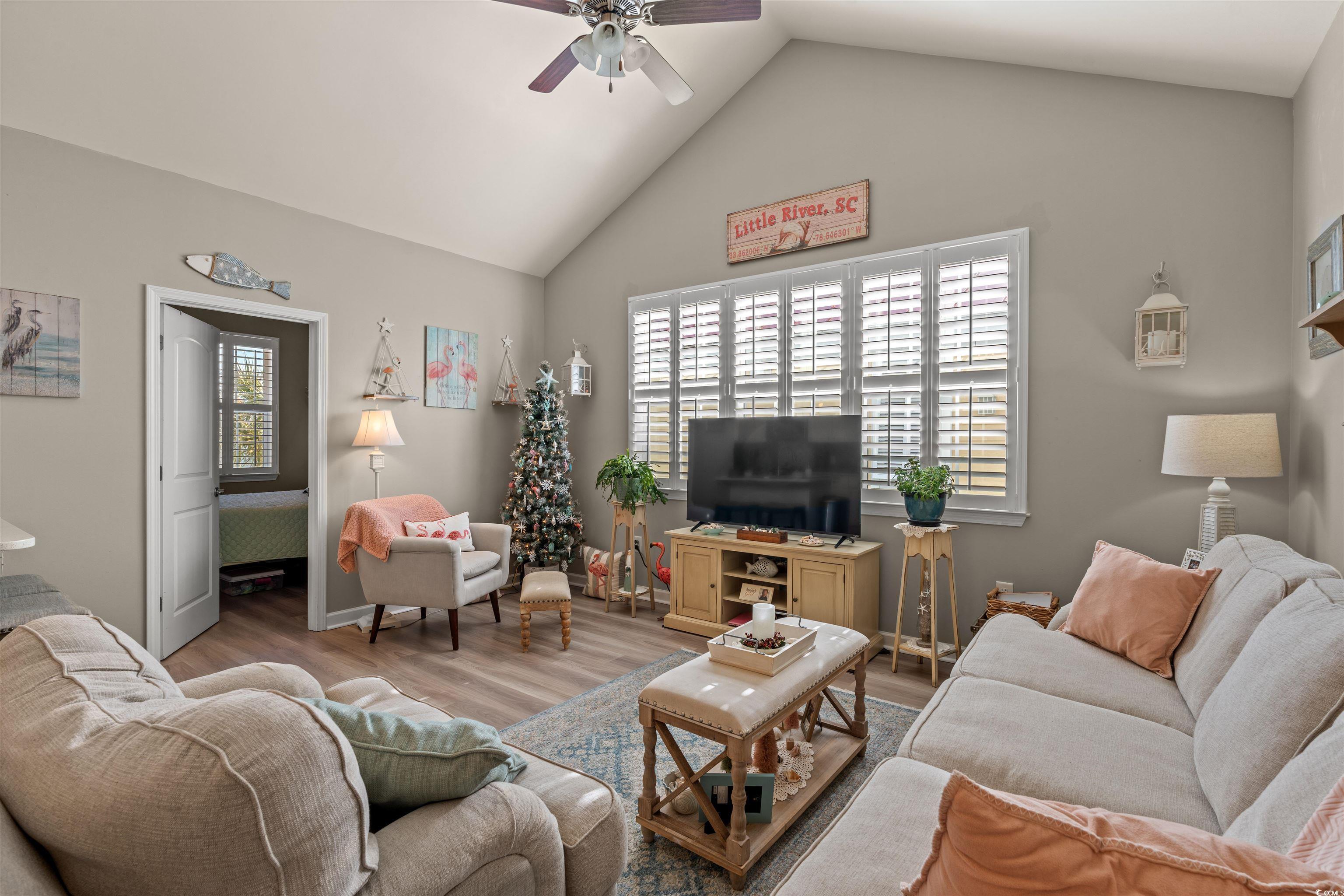 Image 3: Living area with a ceiling fan, plenty of natural