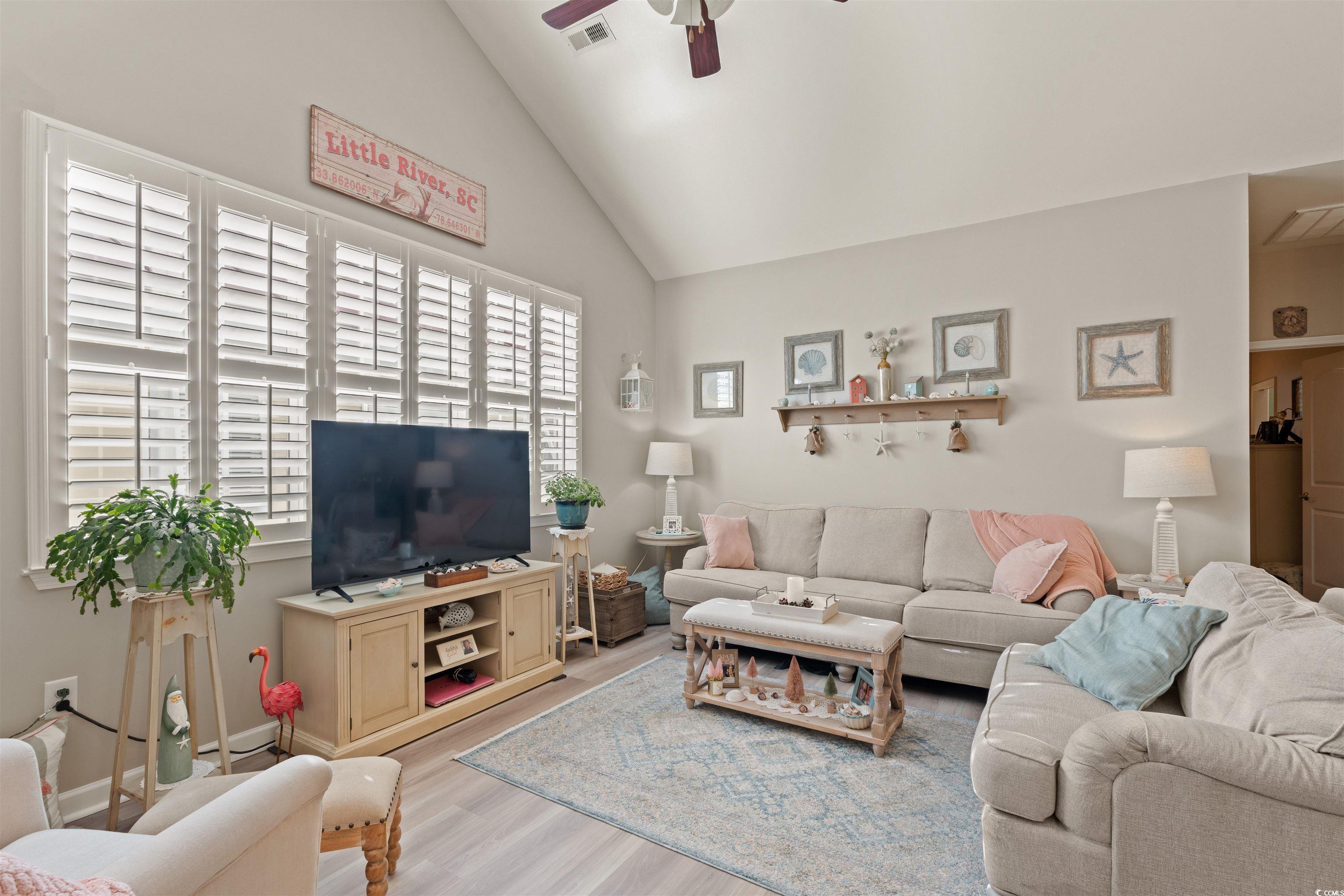 Image 4: Living room with wood finished floors, high vaulte