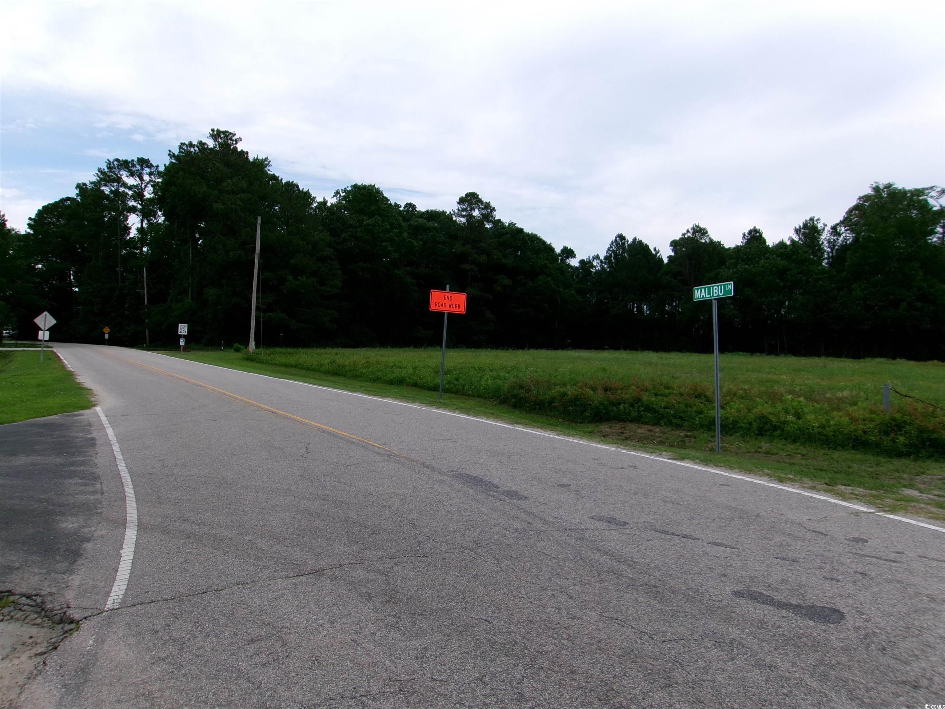 Image 3: View of asphalt road with traffic signs and a view Image 3: View of asphalt road with traffic signs and a view