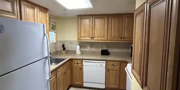Image 4: Kitchen featuring a skylight, white appliances, a