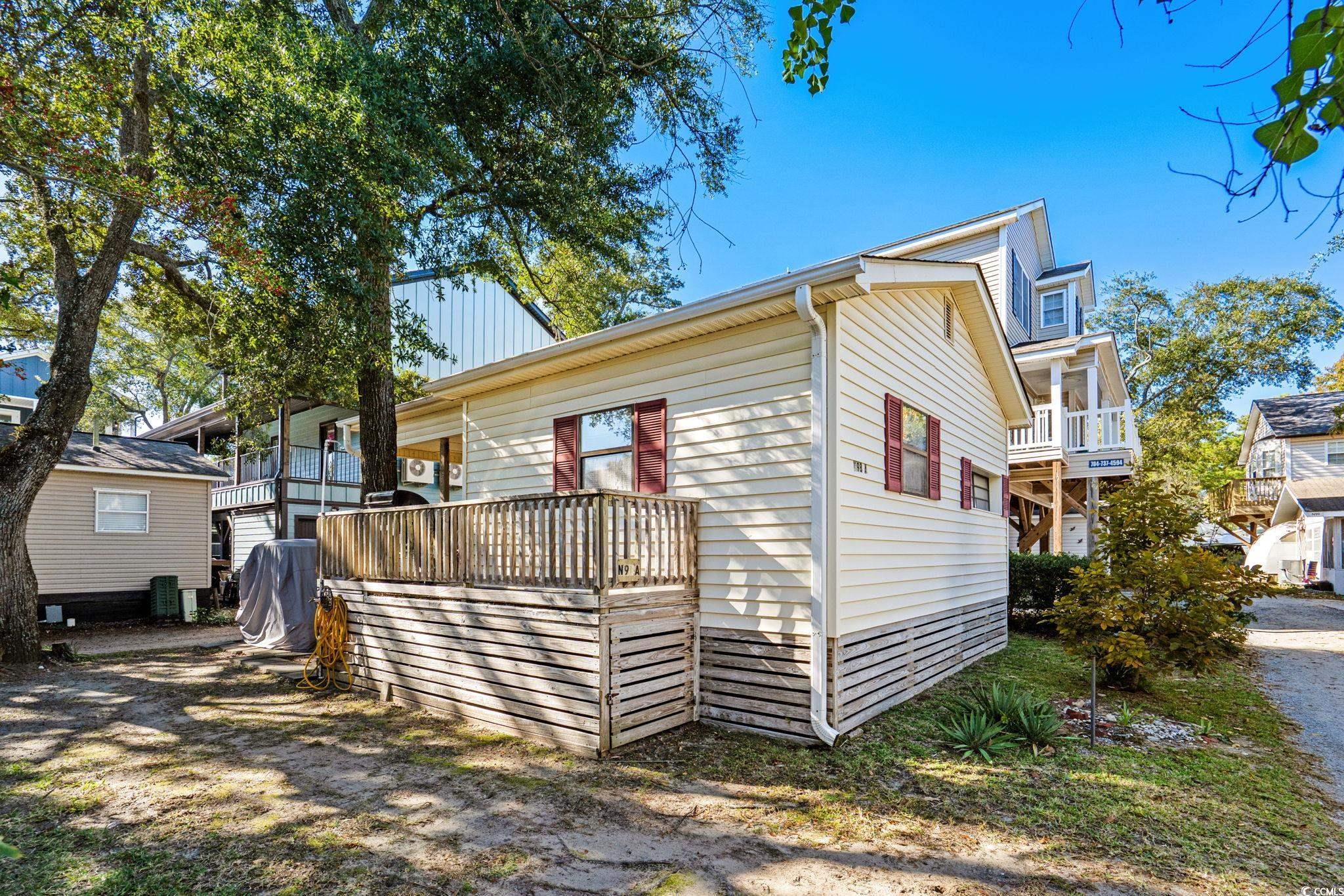 Image 2: View of property exterior featuring a wooden deck Image 2: View of property exterior featuring a wooden deck