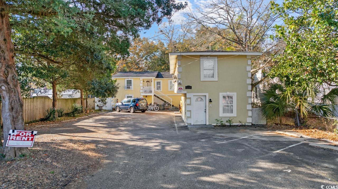 Image 3: Back of property featuring stairs and uncovered pa Image 3: Back of property featuring stairs and uncovered pa
