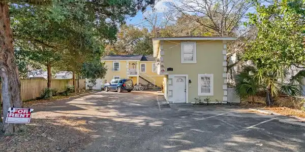 Image 3: Back of property featuring stairs and uncovered pa