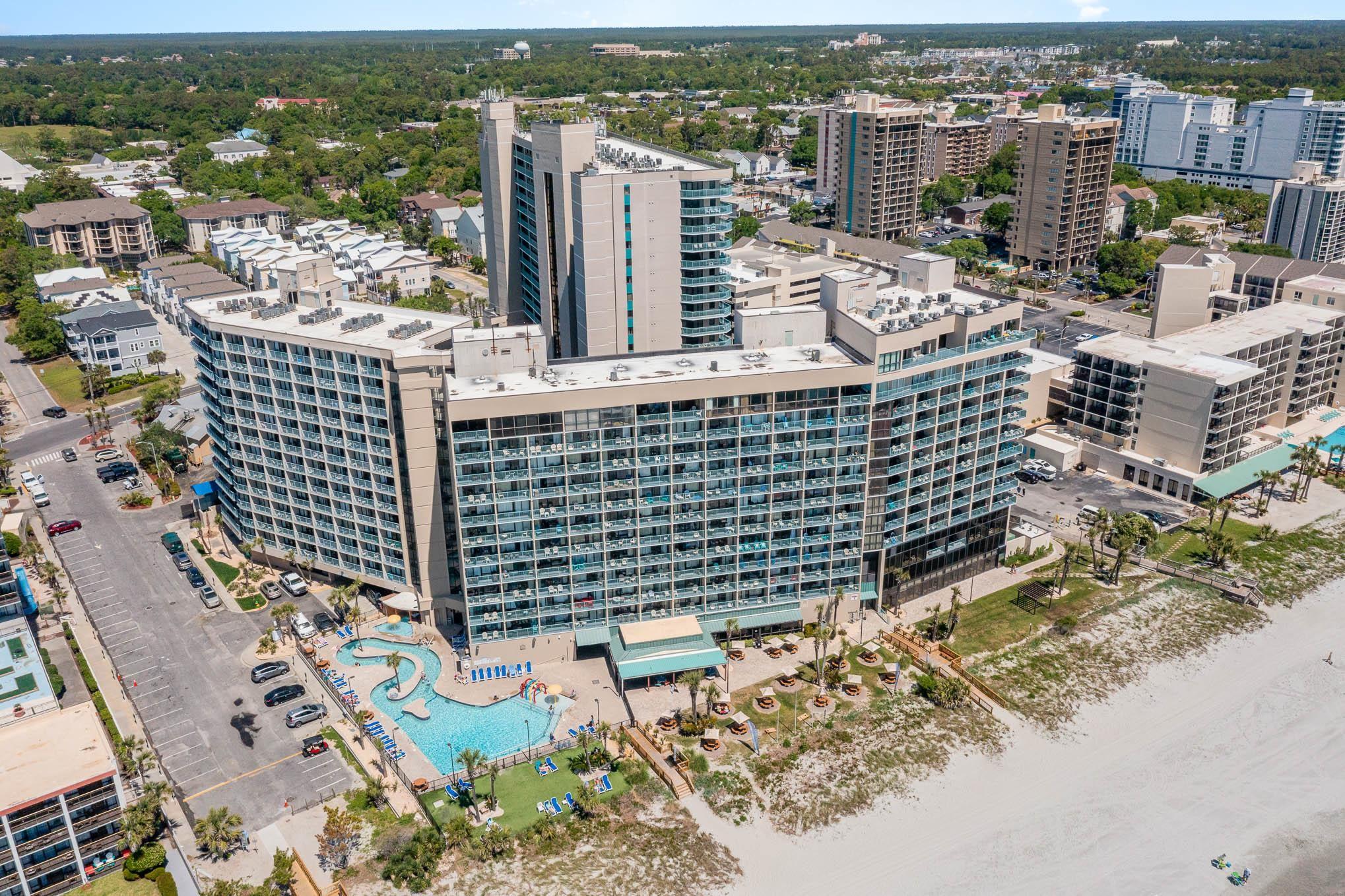 Image 1: View of urban area featuring a pool area