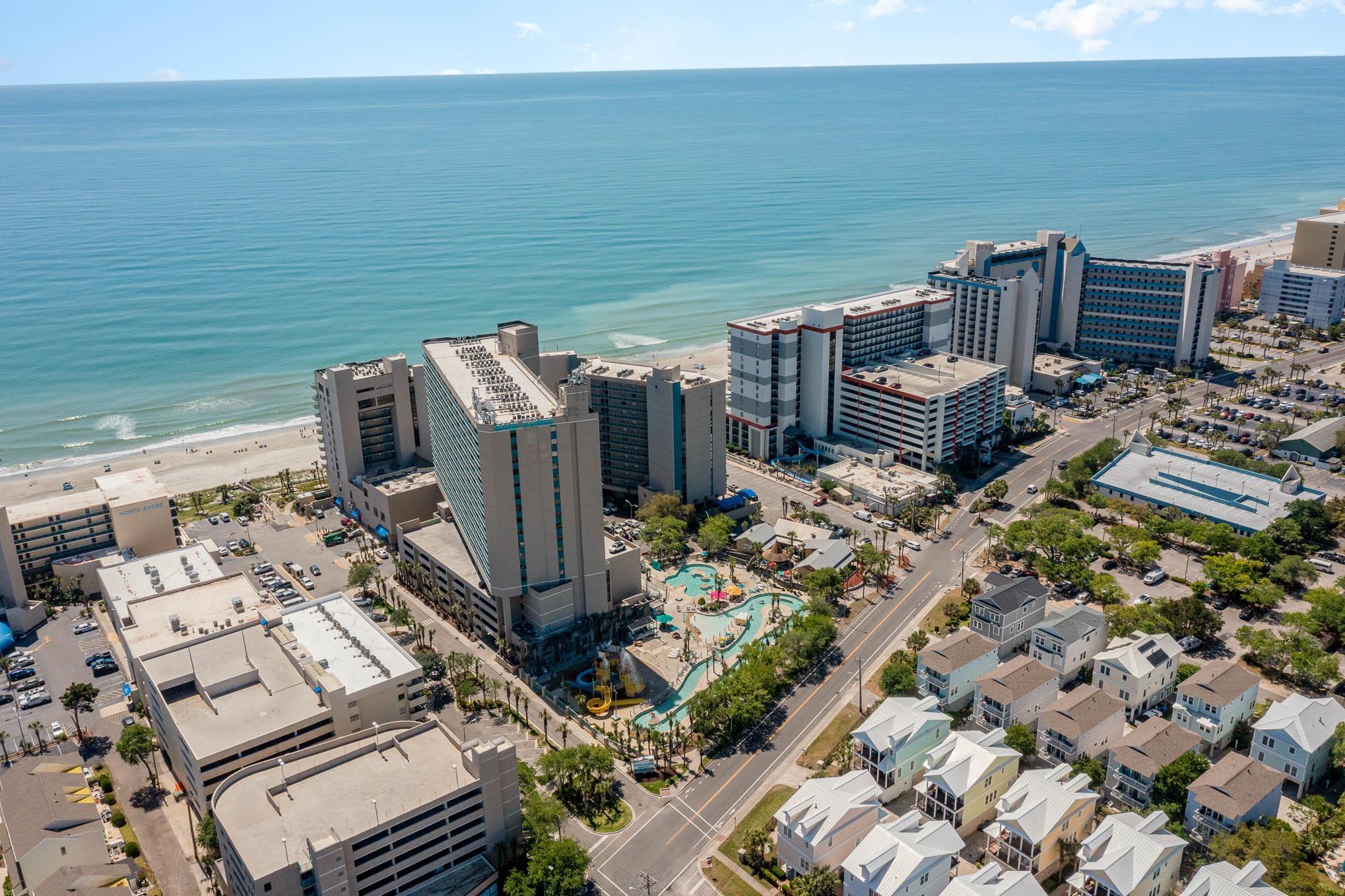 Image 3: View of urban area featuring waterfront with a bea