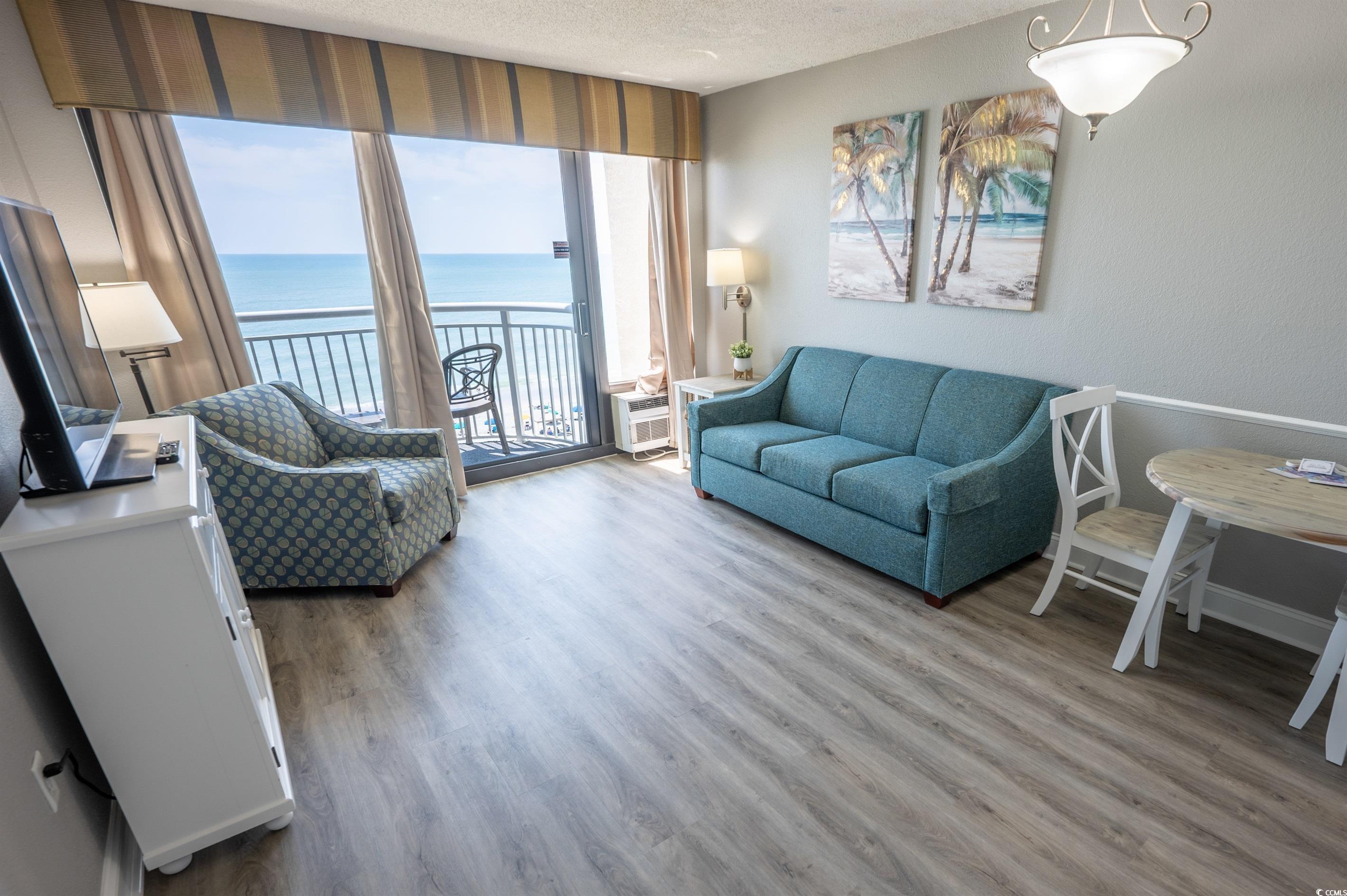 Image 4: Living room with a water view, wood-type flooring, Image 4: Living room with a water view, wood-type flooring,