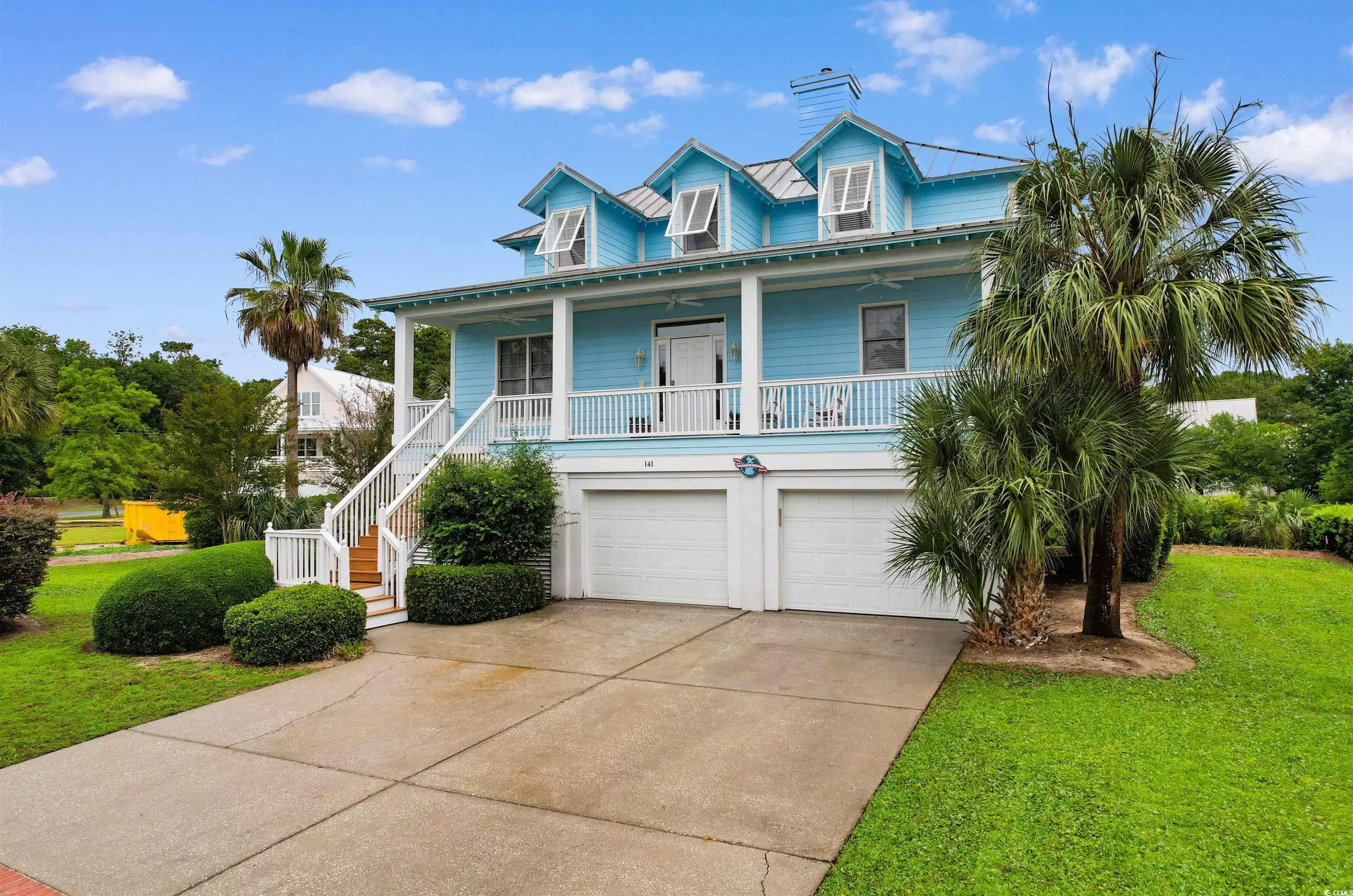 Image 1: Coastal home with driveway, a front yard, a garage Image 1: Coastal home with driveway, a front yard, a garage