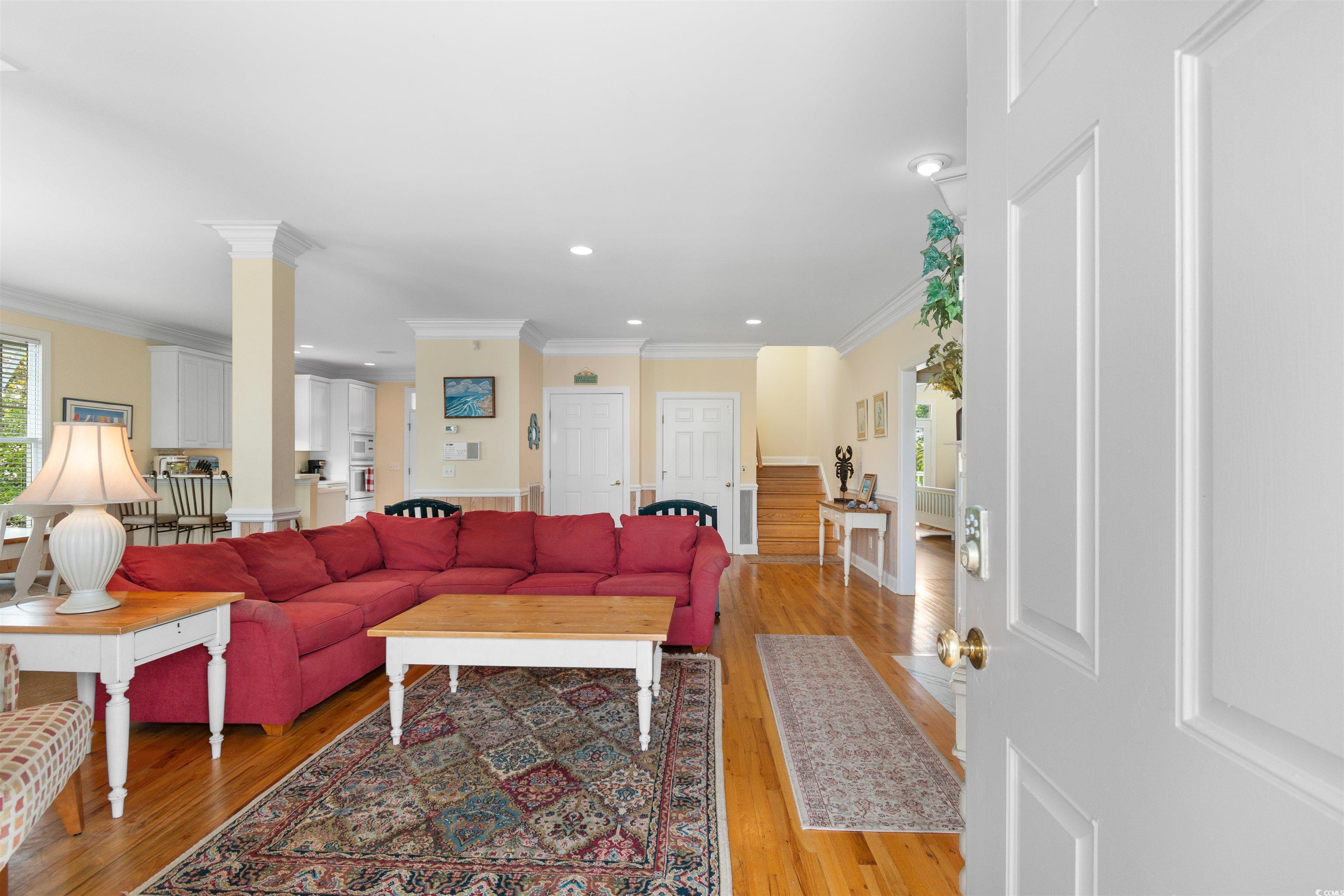 Image 3: Living area featuring crown molding, light wood fi Image 3: Living area featuring crown molding, light wood fi