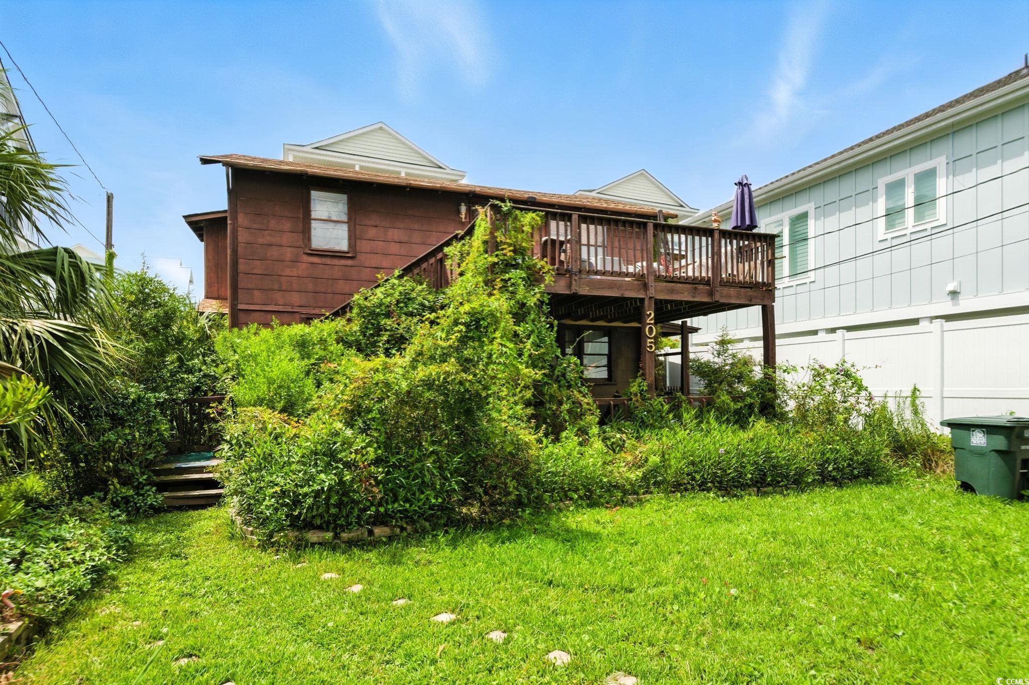 Image 2: Rear view of house featuring a wooden deck