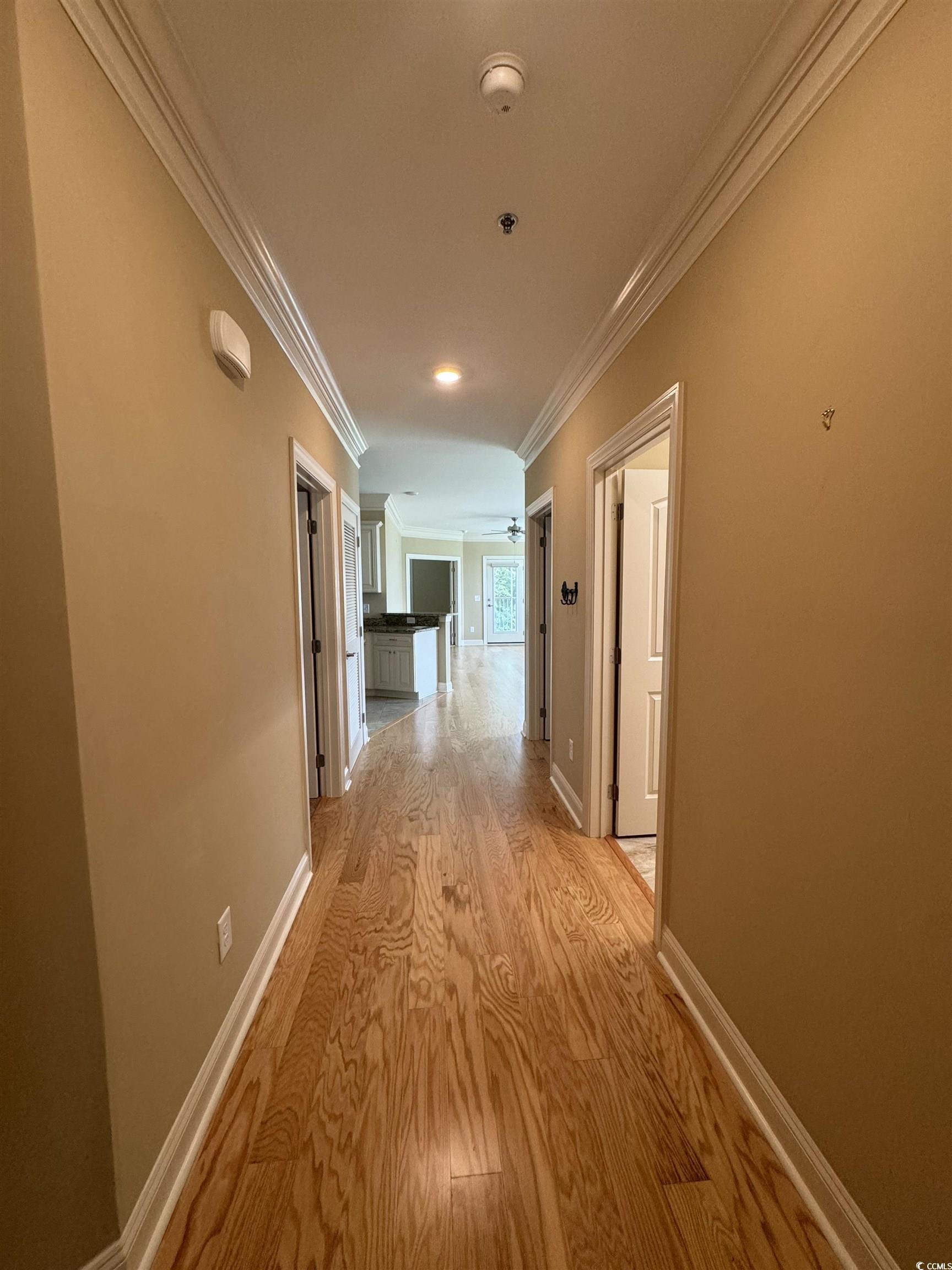 Image 3: Hall featuring light wood finished floors and crow