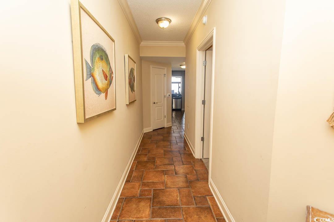 Image 2: Hall featuring stone tile flooring, baseboards, an Image 2: Hall featuring stone tile flooring, baseboards, an