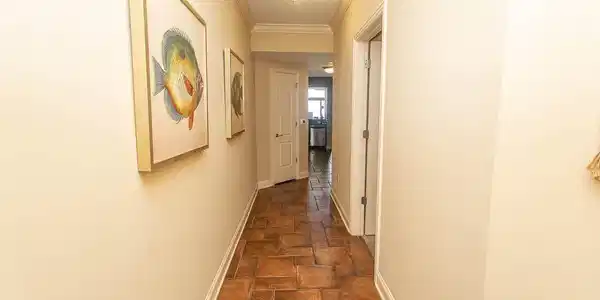 Image 2: Hall featuring stone tile flooring, baseboards, an Image 2: Hall featuring stone tile flooring, baseboards, an