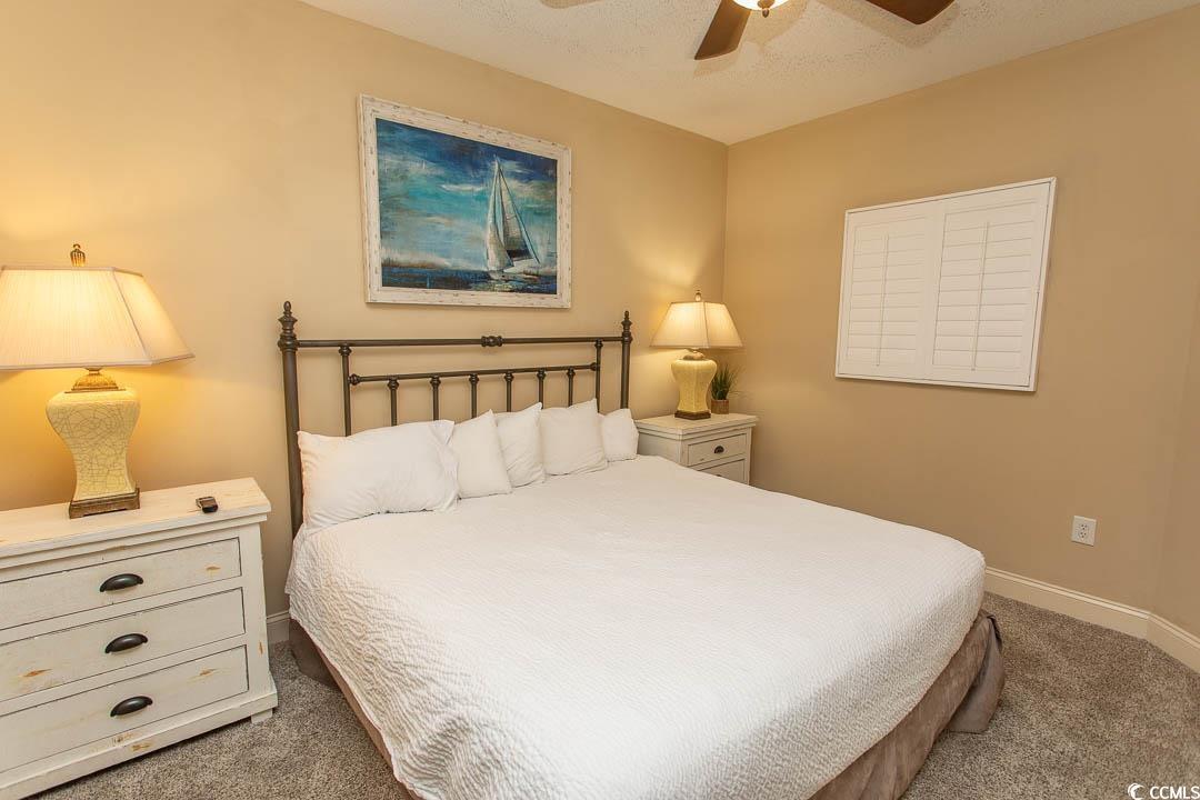 Image 4: Carpeted bedroom featuring baseboards and a ceilin Image 4: Carpeted bedroom featuring baseboards and a ceilin