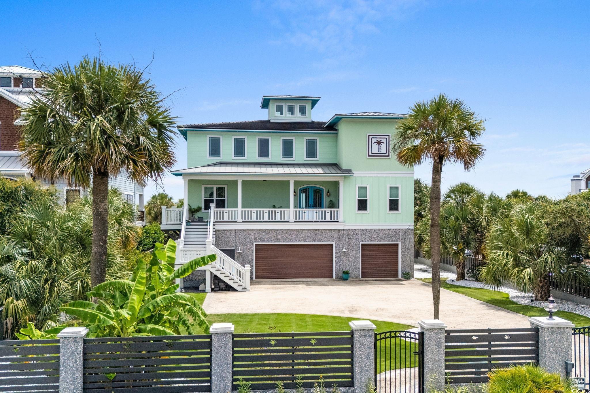 Image 1: Coastal inspired home with stairs, a balcony, driv