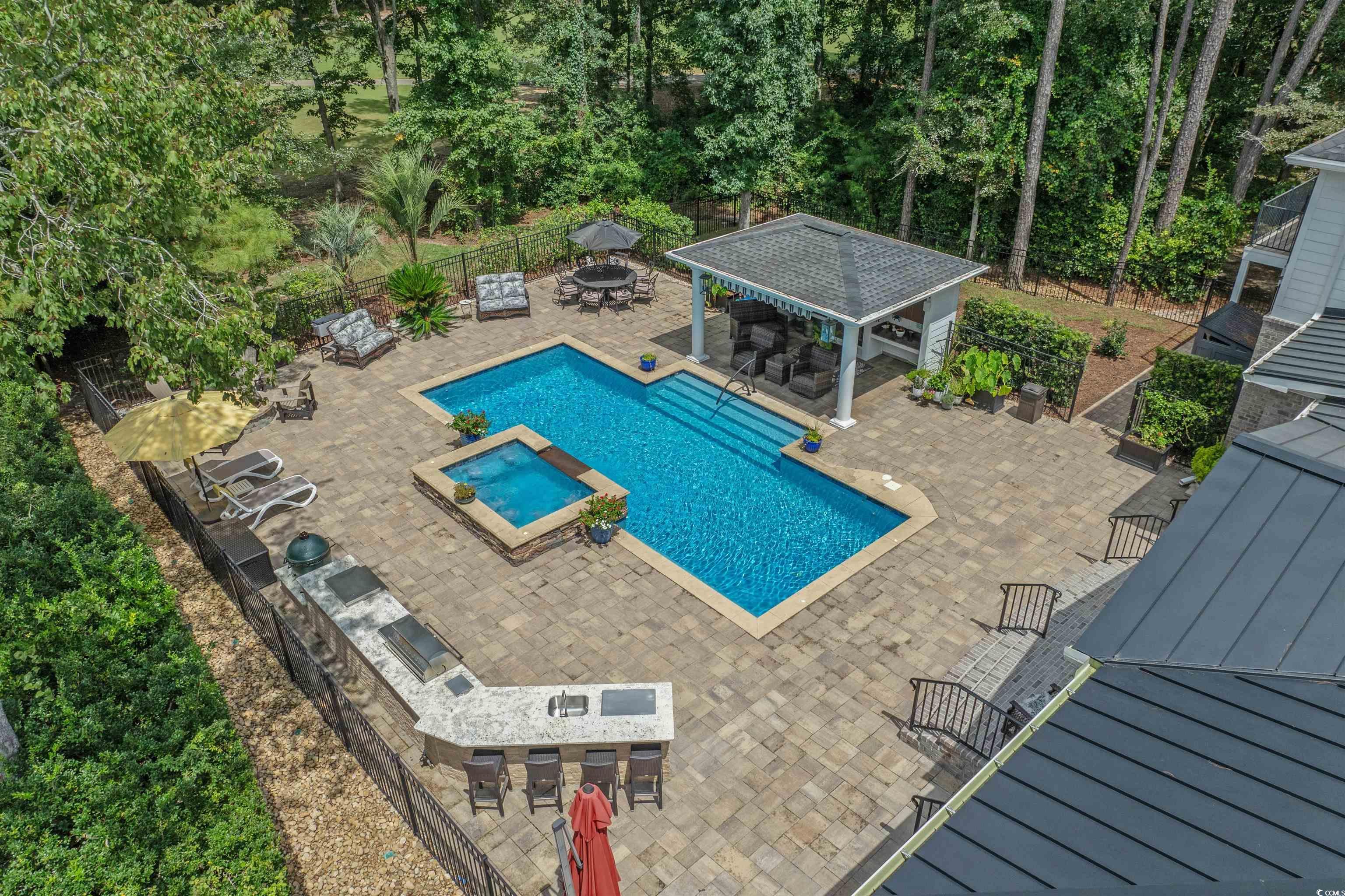 Image 4: View of swimming pool with a patio, a pool with co