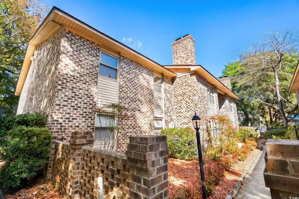 Image 1: View of property exterior featuring a chimney and