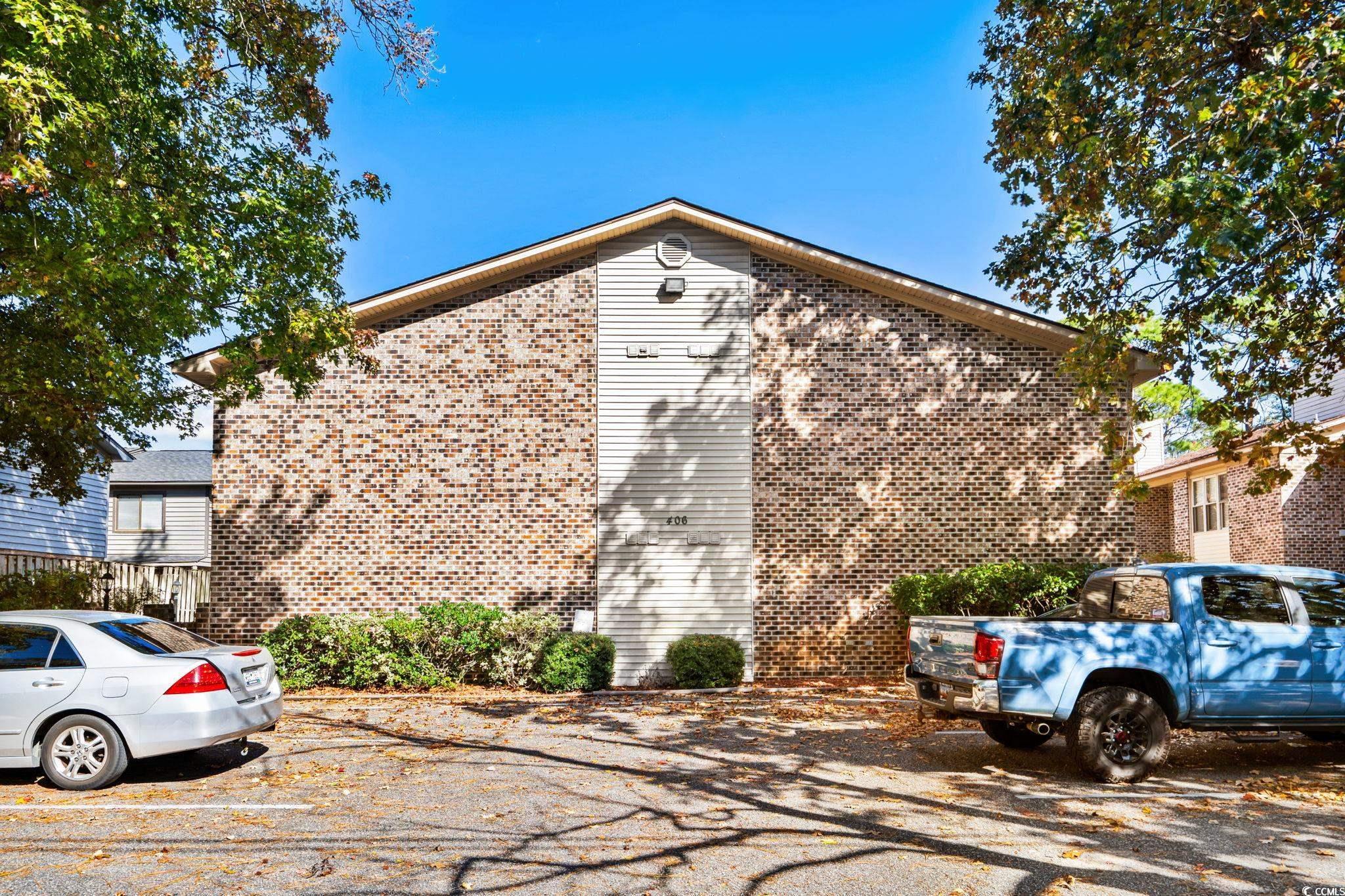 Image 2: View of home's exterior with uncovered parking and Image 2: View of home's exterior with uncovered parking and