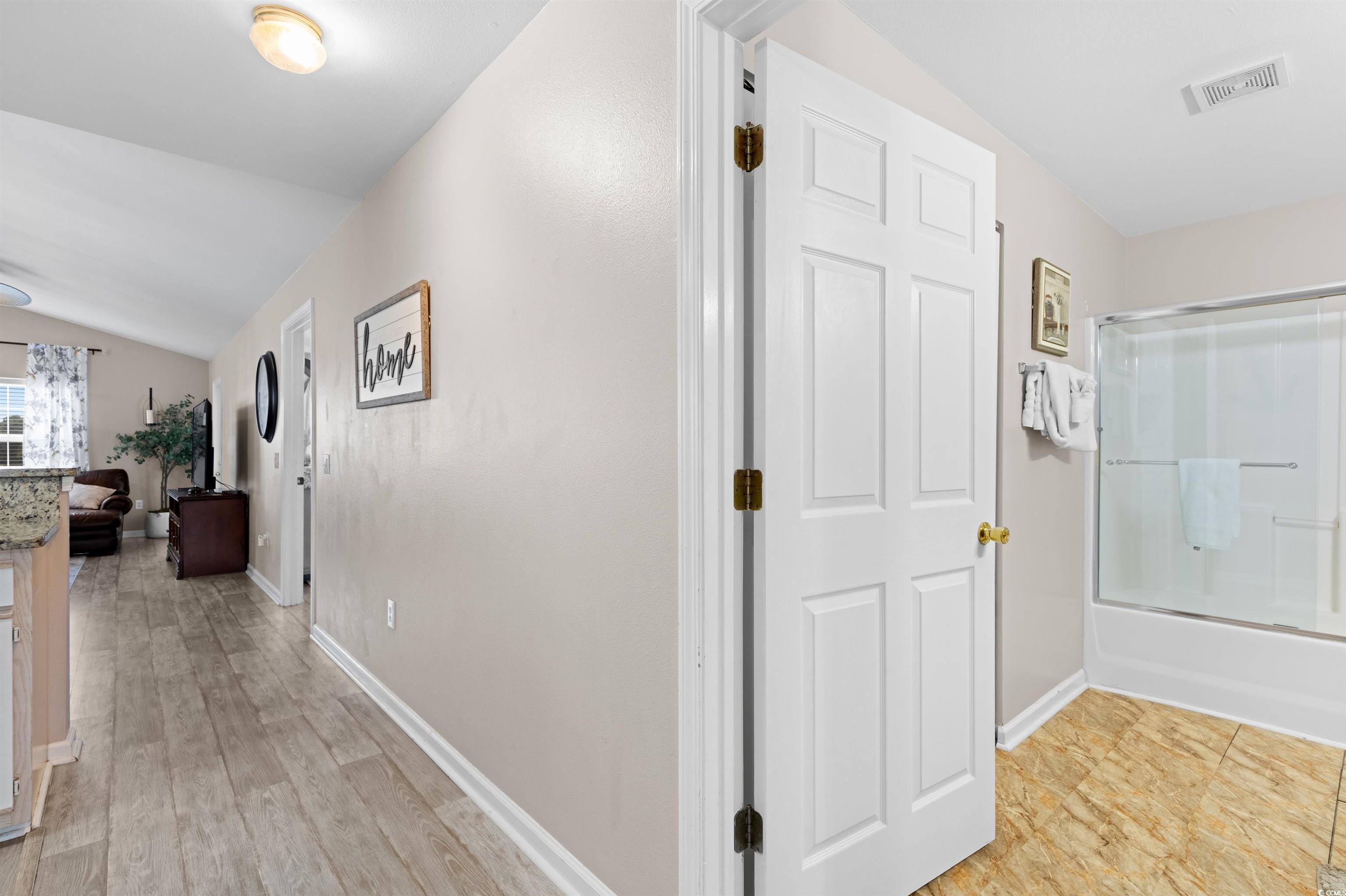 Image 3: Corridor with lofted ceiling and baseboards